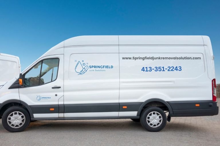 Three white vans labeled "waterproofing" parked in Springfield, IL, representing a junk removal service.